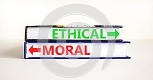 Ethical or moral symbol. Concept word Ethical or Moral on beautiful books. Beautiful white table white background. Business and