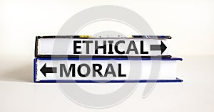 Ethical or moral symbol. Concept word Ethical or Moral on beautiful books. Beautiful white table white background. Business and