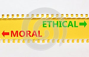 Ethical or moral symbol. Concept word Ethical or Moral on beautiful yellow paper. Beautiful white paper background. Business and