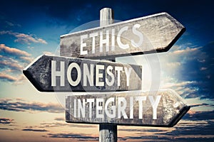 Ethics, honesty, integrity - wooden signpost, roadsign with three arrows