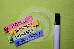 Ethics, Respect, Honesty, Integrity text on sticky notes isolated on green desk. Mechanism Strategy Concept