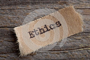 Ethics word on a piece of paper close up, business creative motivation concept