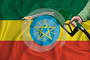 ETHIOPIA flag Close-up shot on waving background texture with Fuel pump nozzle in hand. The concept of design solutions. 3d