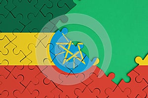 Ethiopia flag is depicted on a completed jigsaw puzzle with free green copy space on the right side