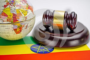 Ethiopia flag and Judge hammer with globe world map. Law and justice court.