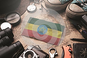 Ethiopia Flag Between Traveler`s Accessories on Old Vintage Map. Tourist Destination Concept