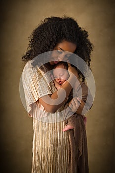 Ethiopian Mom in gold dress with baby