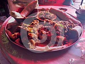 Ethiopian non-vegetarian food-Injera with wot made with mutton spiced butter and other stuffs