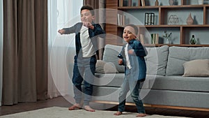 Ethnic African American multiethnic boys kids schoolboys pupils sons indoors children brothers friends dancing to song
