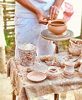 Ethnic art, skilled master creating pot of clay