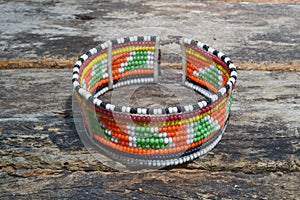 Ethnic beaded jewelry isolated on wooden