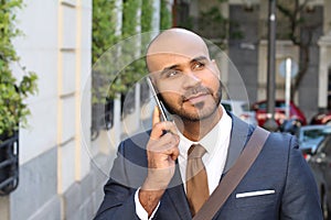 Ethnic businessman using smart phone in the city