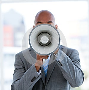 Ethnic businessman yelling through a megaphone