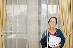 Ethnic elderly woman patient in hospital ward