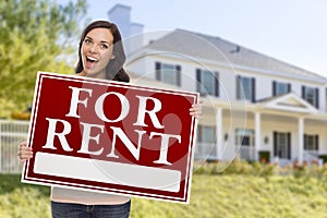 Ethnic Female Holding For Rent Sign In Front of House