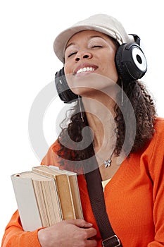 Ethnic girl enjoying music through earphones