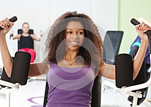 Ethnic girl exercising at the gym