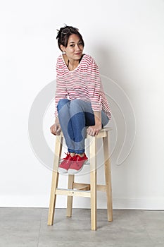 Ethnic girl sitting on a stool enjoying student wellbeing