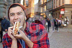 Ethnic male devouring a hot dog