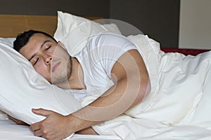 Ethnic male sleeping in comfortable position photo