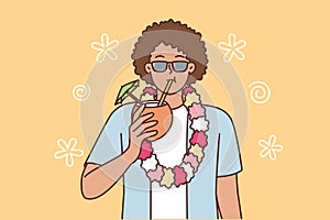 Ethnic man tourist from island of Hawaii drinks coconut cocktail and invites to beach party