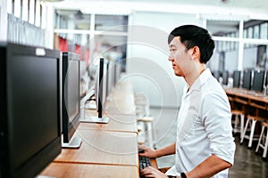 Ethnic man using computer in classroom