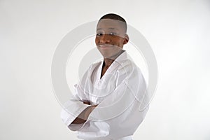 Ethnic teenager smiling in a karate uniform