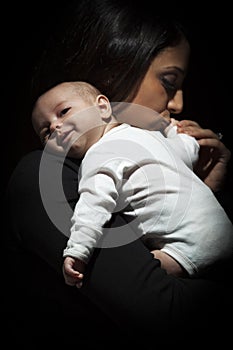 Ethnic Woman Kisses Her Newborn Baby Hand