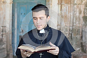 Ethnic young priest reading