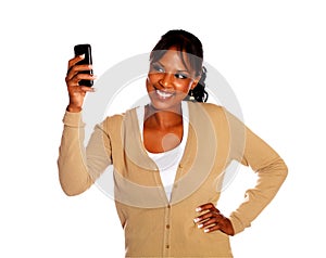 Ethnic young woman sending message by cellphone