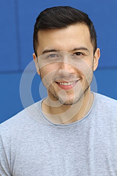 Ethnically ambiguous male smiling close up photo