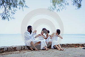 Ethnicity Happy Family Africans Enjoy relaxation resting on the beach summer vacation time