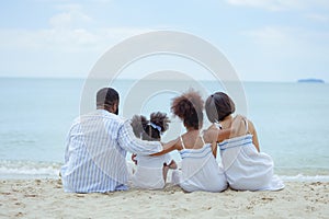 Ethnicity Happy Family Africans Enjoy relaxation resting on the beach summer vacation time photo