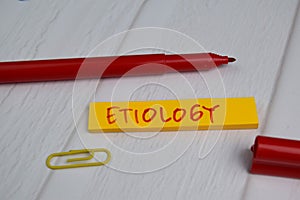 Etiology write on sticky notes isolated on office desk