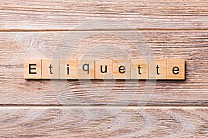 ETIQUETTE word written on wood block. ETIQUETTE text on wooden table for your desing, concept