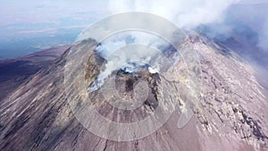 Etna - Panorama of the crater of the volcano of Sicily with smoke and magma