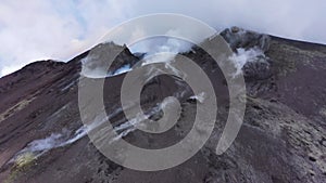 Etna - Panorama of the crater of the volcano of Sicily with smoke and magma