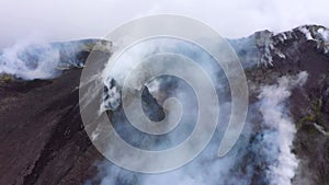 Etna - Panorama of the crater of the volcano of Sicily with smoke and magma