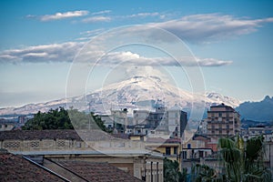 Etna with snow seen from the center of Catania