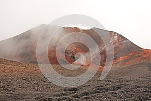 The Etna volcano. The Etna volcano crater. Black Volcanic Earth, Volcanic Lava and Stones. Dense Fog on Mount Etna. Place for