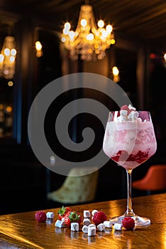 Eton mess raspberry and marshmallow alcoholic cocktail at the bar