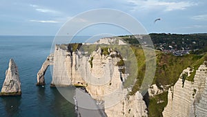 Etretat, Normandy, France. Cliffs Aval and Needle with beautiful famous coastline during the tide at sunset. Aerial view