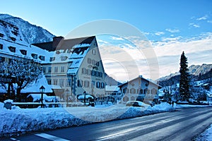 Alpine village snowy landscape icy street at blue hour