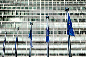 EU European Union flags in front of European Comission building in Background. Brussles, Belgium