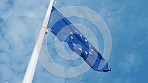 EU flag. Flag of European Union. Blue sky on the background
