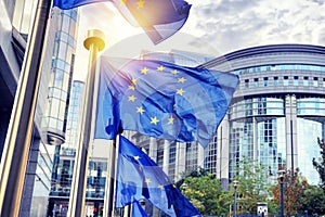 EU flags waving in front of European Parliament building in Brus