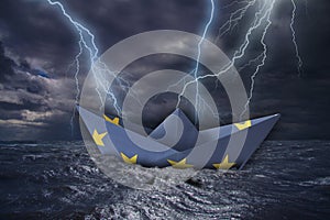 EU paper boat made as the flag of the European Union almost capsizes in high waves and bolt of lightning