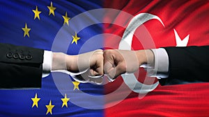 EU vs Turkey conflict, international relations crisis, fists on flag background