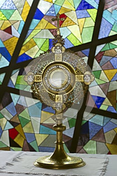 Eucharistic adoration on colorful church wall backgrounds in the chapel. Silence prayer for healing. Catholic prayer symbol.