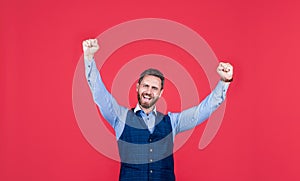 Euphoric business man celebrate success or victory making winner gesture red background, euphoria